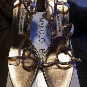 Brand new pair of Manolo Blahnik gold shoes.